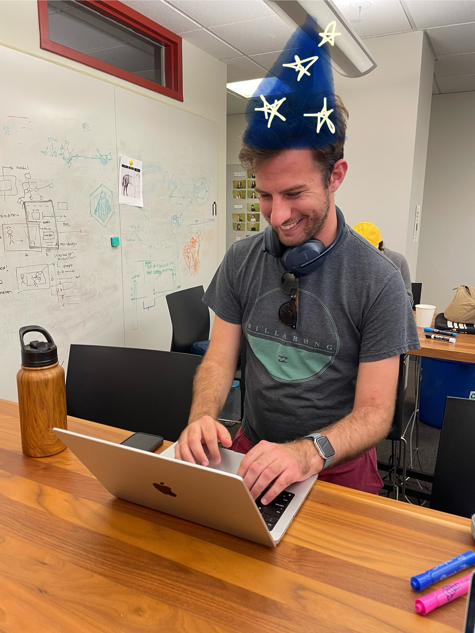 A person wearing a wizard hat, looking at a laptop, representing the 'Wizard of Oz' test setup.